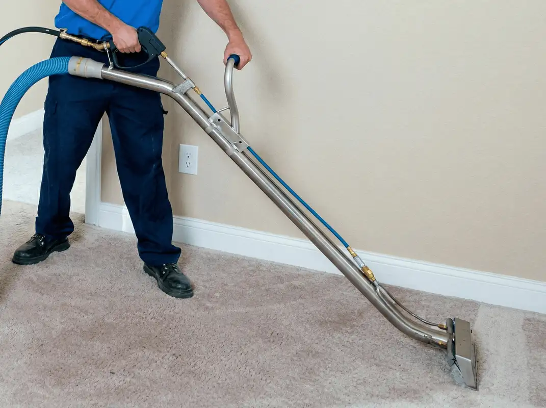 Professional operating a liquid removal machine on a carpeted floor in New Haven, CT