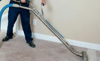 Professional operating a liquid removal machine on a carpeted floor in New Haven, CT